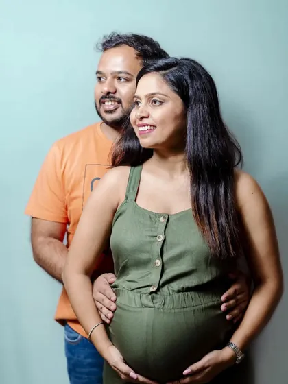 A relaxed and happy couple portrait from a home or studio session. Their smiles and easy posture show how comfortable and joyful this experience can be.