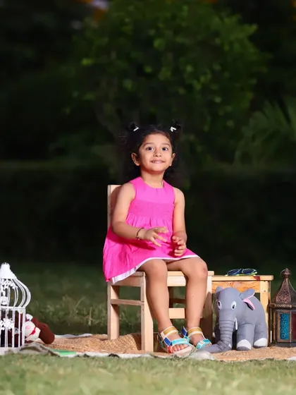 A sweet portrait of a little girl during her outdoor photoshoot. The natural light is so flattering and brings out the beautiful colors of her dress and the surrounding nature.