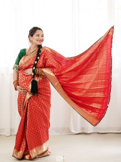 A beautiful shot of the mother-to-be showing off the elegant drape of her silk saree.
