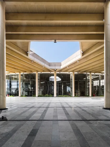 This image accompanies our thoughts on evolving architectural education. The grand, transparent entrance of this institutional building symbolizes an open and accessible approach to learning that we champion in our designs.