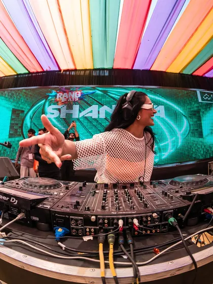 Interacting with the crowd from the DJ booth at the Holi festival. My goal is to make everyone feel like they're part of the celebration.