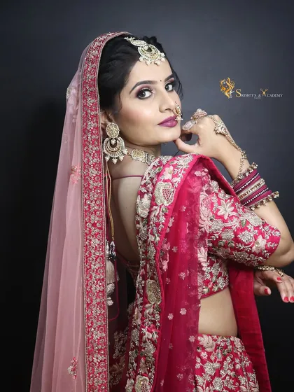 A classic red bridal look with a focus on traditional elements. This image showcases a complete look with detailed embroidery and matching jewelry.