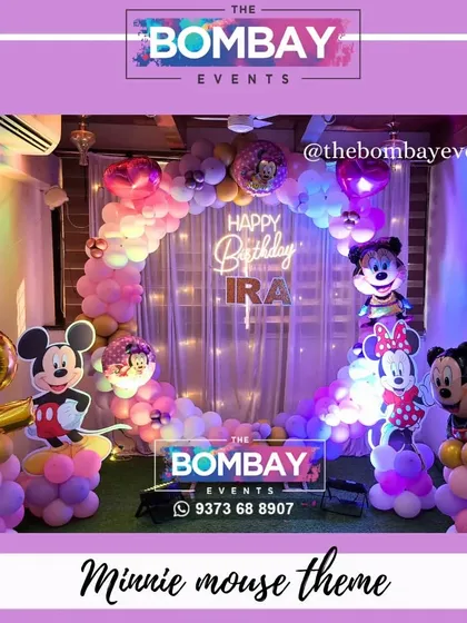 A classic that never goes out of style! This Minnie and Mickey Mouse theme for a 2nd birthday uses a beautiful pastel and purple color palette, with a circular balloon arch and character cutouts.