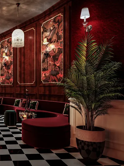 A visualization of a restro-bar in Pune, with deep red walls, serpentine seating, and custom murals. The checkerboard floor adds a classic, graphic element.