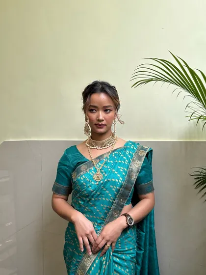 A full-length view of the South Indian bridal look, demonstrating how our students learn to consider the entire aesthetic, from makeup to saree draping.