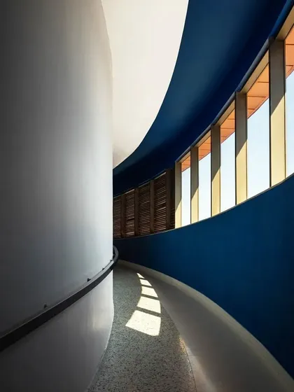 A curved corridor at the MARC Auditorium, where natural light plays across the surfaces. This space exemplifies our approach to creating architecture that is both functional and poetic.