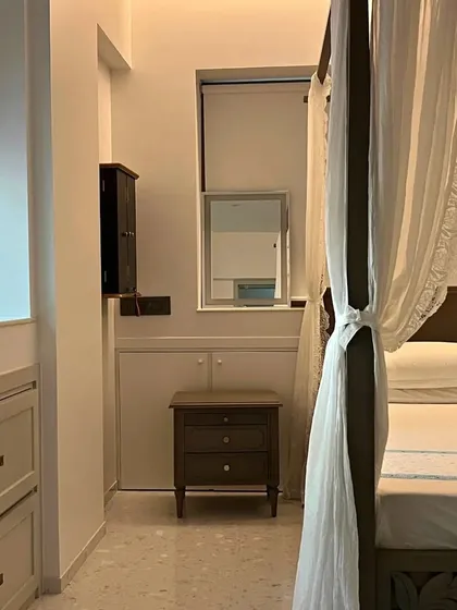The four-poster bed in this Bohemian-style home creates a romantic and ethereal focal point. The sheer curtains soften the space, contributing to a relaxed and inviting atmosphere.