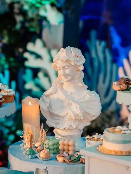 A close-up of the dessert table, featuring cupcakes and mini cakes displayed on themed stands. Even the food presentation is an integral part of the overall design.