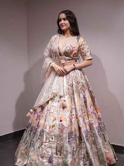Paint your own masterpiece in this vibrant multicolored cream lehenga, intricately embroidered with threads of tradition and tales of heritage.