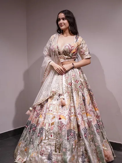 Paint your own masterpiece in this vibrant multicolored cream lehenga, intricately embroidered with threads of tradition and tales of heritage.