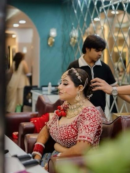 A behind-the-scenes moment as we perfect the bridal bun. This shows the care and attention to detail that goes into creating a complete, polished look for the wedding day.