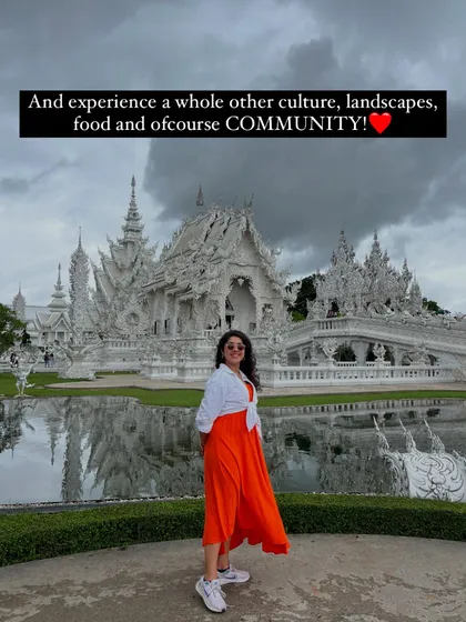On our trips, you get to experience a whole new culture, landscape, and of course, community. Here's our host in front of a stunning white temple, ready for the next discovery.