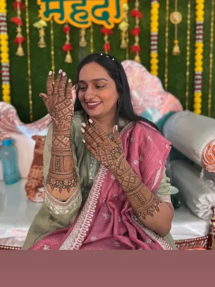 A candid shot of a bride admiring her intricate mehendi during her ceremony.