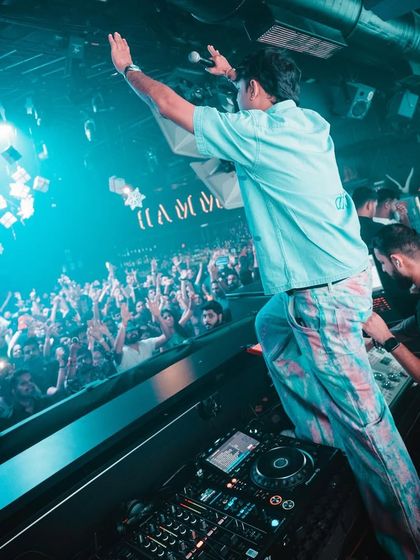 Standing on the console to get the crowd even more hyped at a club in Goa.