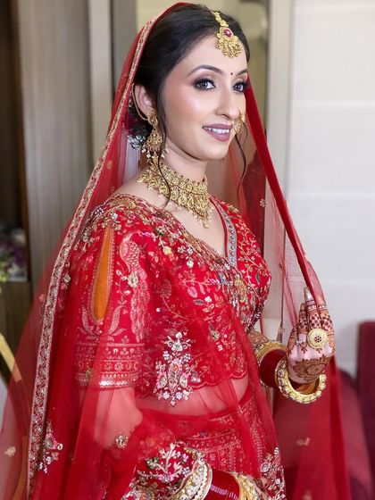 A beautiful shot of my bride holding her dupatta. The classic red and gold combination is timeless, and her dewy makeup keeps the look fresh and modern.