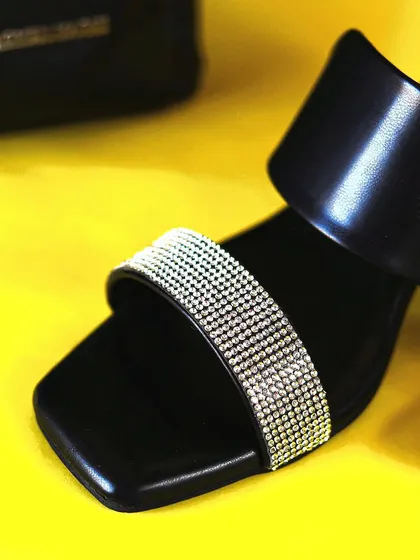 An extreme close-up on the crystal-studded strap of the Dressberry heel, perfect for highlighting product quality and detail.