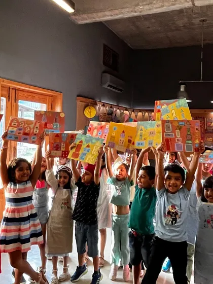 The pure joy of creation. A class of young artists celebrates completing their vibrant cityscape paintings. We love seeing our studio filled with this kind of energy and accomplishment.