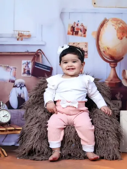 An eleven-month milestone shoot with a vintage traveler theme, complete with globes and suitcases.