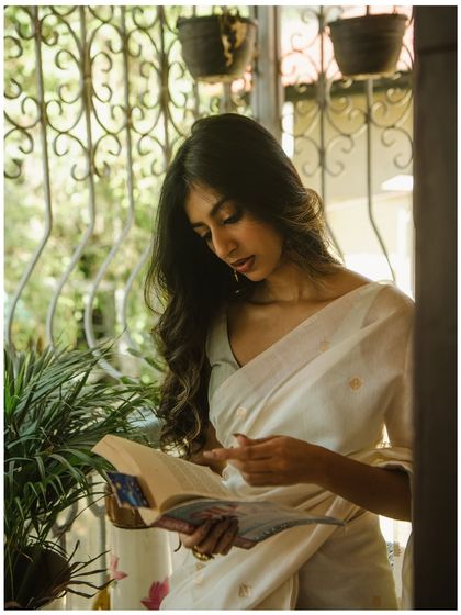 A lifestyle-inspired shot of the model reading by a window. This adds a narrative element to the series, making it feel more personal.