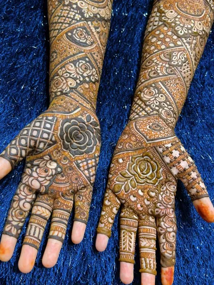 A close-up of the palms for a full-coverage bridal design. The patterns are a beautiful mix of floral and geometric motifs.
