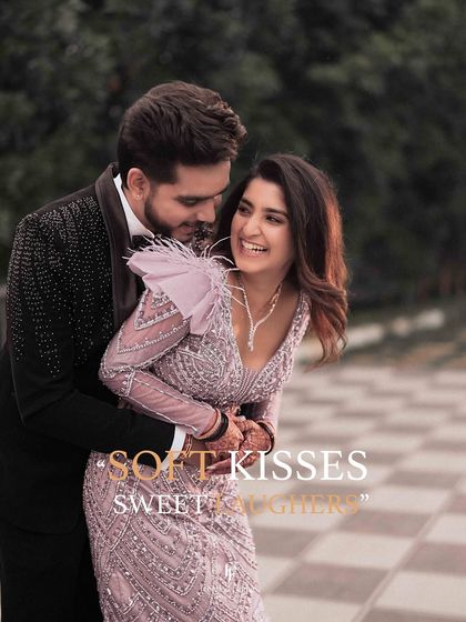 A happy, candid moment from a reception, with the groom hugging the bride from behind. The title "Soft Kisses, Sweet Laughters" says it all.