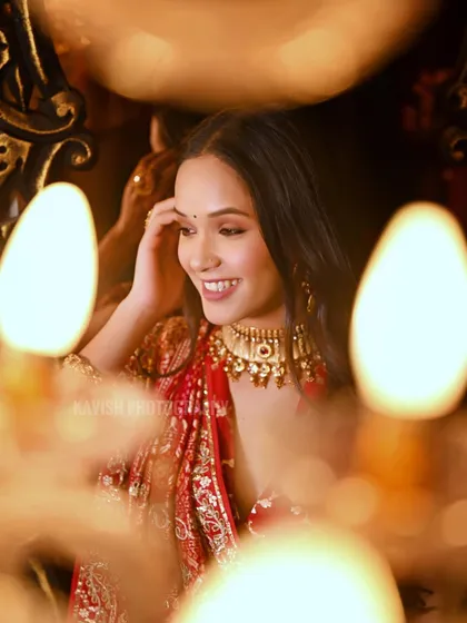 A candid, smiling moment from the same candlelit studio session.