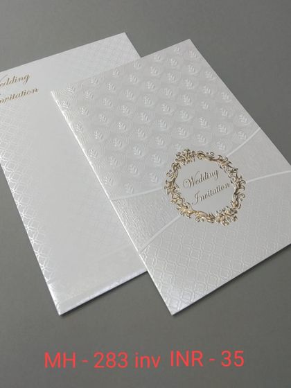 A very simple and affordable white invitation with a textured background and a classic gold wreath emblem. Perfect for a clean and minimalist announcement.