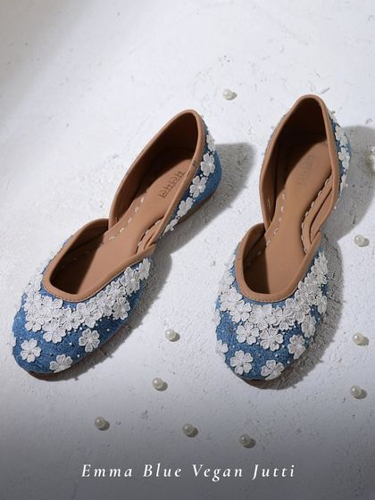 The Emma Blue Vegan Jutti is like a garden for your feet. Adorned with delicate 3D organza flowers, these denim-blue juttis are perfect for adding a fresh, whimsical touch to your daytime outfits.