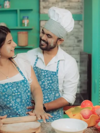 Love is cooking up something beautiful! This couple shares a laugh in a quirky kitchen setting, a perfect example of a themed pre-wedding shoot that reflects shared interests and creates fun, natural interactions.