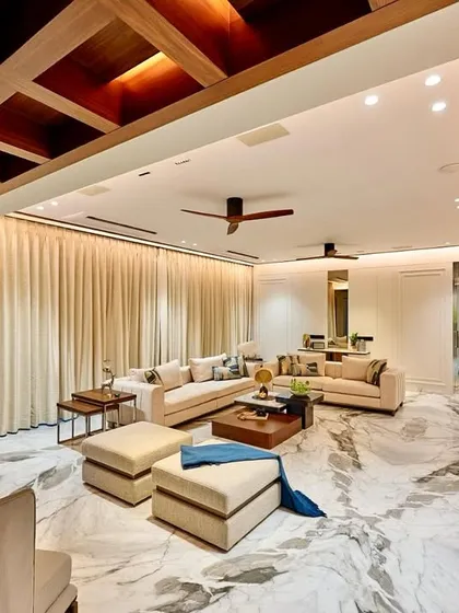 This wide view captures the essence of serene luxury. The design combines a sprawling marble floor with warm wood accents, backlit Onyx panels, and comfortable, low-profile seating to create a space that is both grand and welcoming.