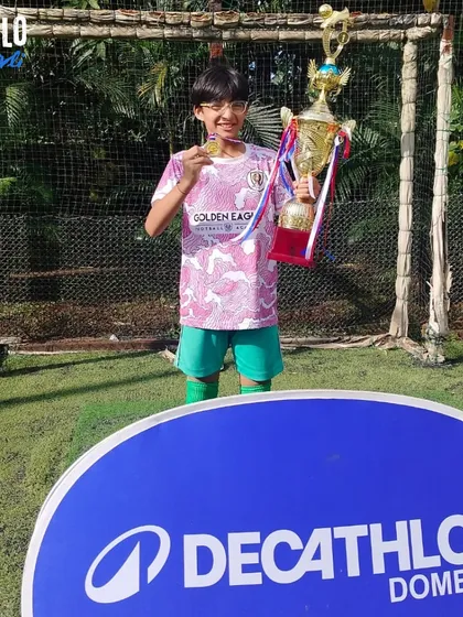 Another one of our champion girls with her trophy. We celebrate every player's contribution to the team's success.