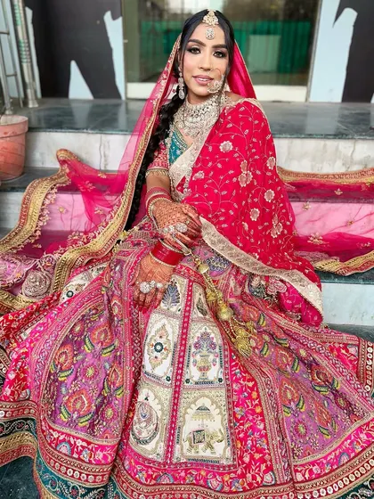 A full view of the stunning bridal lehenga and makeup, demonstrating the complete look our students learn to create.
