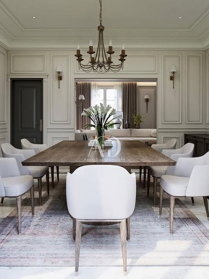 A direct view of the dining table, showing the clean lines of the chairs and the solid presence of the table. The space is designed to feel open and connected to the adjacent living area, perfect for modern family life.