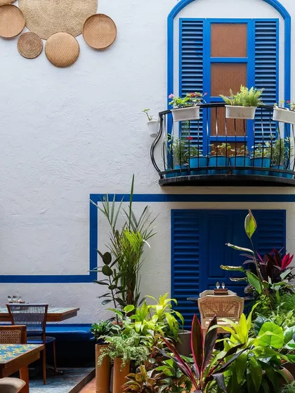 Inspired by the serene courtyards of Greece, this restaurant space uses a classic blue and white palette, abundant greenery, and natural textures. The design creates a bright, airy, and refreshing escape in the middle of the city.