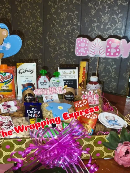 A hamper for a baby-related ceremony, packed with snacks, dry fruits, and chocolates for the family.
