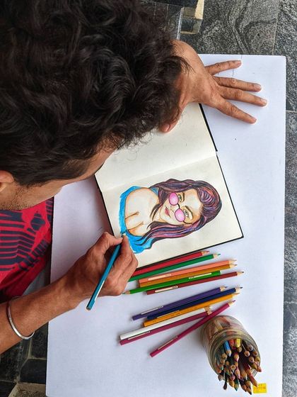 Working on a portrait sketch with colored pencils. This shows the foundational stage of drawing and coloring, an essential skill for any artist that we practice together in a relaxed and supportive environment.