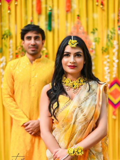 A lovely couple portrait from a Haldi ceremony. Dressed in coordinated yellow outfits, they radiate the bright and happy spirit of the occasion.