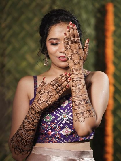 Another playful pose from the same bride, showing her joy and the beauty of her bridal henna.