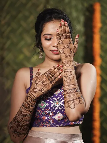 Another playful pose from the same bride, showing her joy and the beauty of her bridal henna.