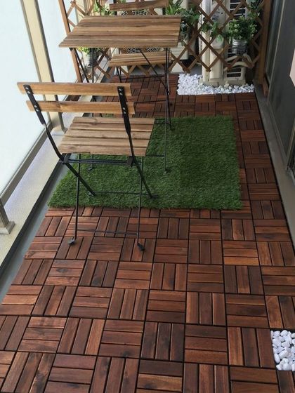 Here, I've used a mix of materials to add texture and design to the balcony floor. The majority of the space is covered in rich wooden deck tiles, with a small artificial grass patch to place the bistro set on.