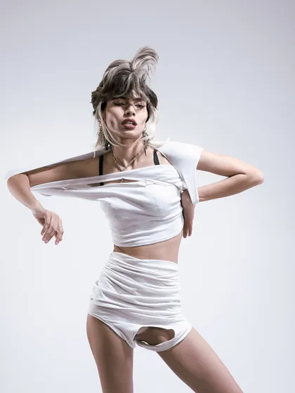 The energy is building in this shot from the deconstructed series. The model's pose is more dynamic, and the torn fabric starts to take on a life of its own. It's about finding beauty in imperfection.