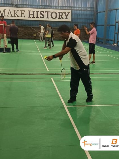 A player gets ready to serve during the Bee Logistics tournament. I provide all necessary equipment, including quality shuttlecocks and court setup.
