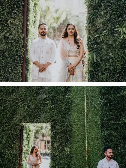 A creative portrait of the couple using a green wall as a natural frame.