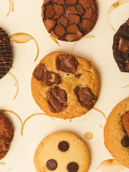Savoring the simple joys of life. This image shows an assortment of our cookies, including a classic chunk cookie, a brookie, and a KitKat cookie.