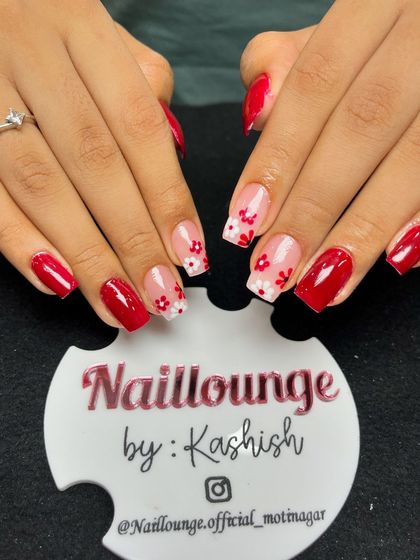 A cute and simple red set with accent nails featuring tiny hand-painted red flowers on a sheer base.