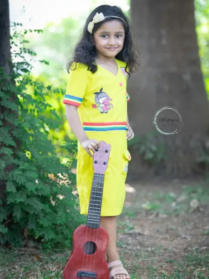 This young lady strikes a confident pose with her guitar during her fifth birthday shoot.