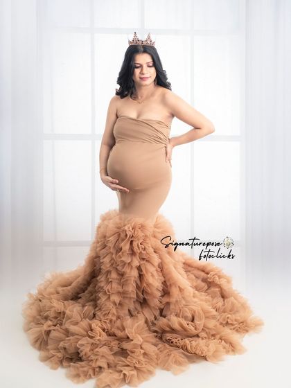 A regal portrait in the ruffled gown, with a crown and soft lighting creating a queenly yet earthy vibe.