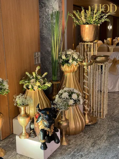 A larger view of the traditional decor corner, showing a cluster of golden vases and a Nandi statue, perfect for adding a touch of heritage to any space.