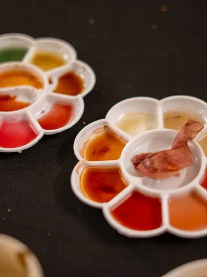 A palette filled with freshly made botanical inks. The beautiful, earthy tones of red, orange, and yellow were all extracted from natural sources like flowers and spices right here in our studio.