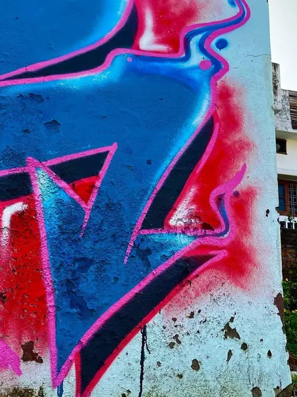 A side angle of the Shiva mural in Dehradun, showing how the 3D lettering of my name "योगी" (Yogi) integrates with the main artwork. The piece is designed to be viewed from multiple angles, with drips and color blends adding texture.